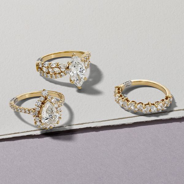 Yellow gold lab-created diamond engagement rings with fancy shape center stones.